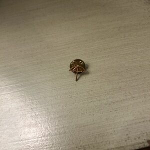 Gold colored umbrella lapel pin